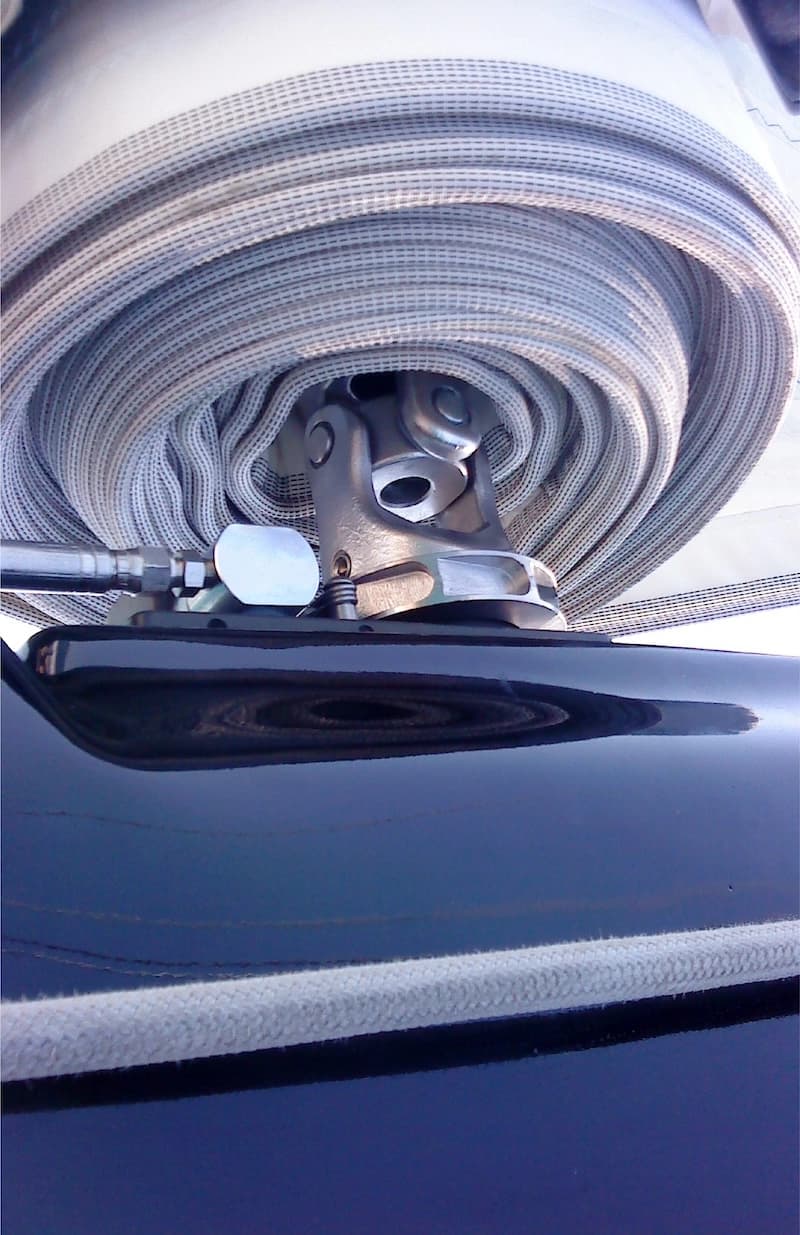 Close-up of coiled rope and sailboat deck hardware used in running rigging systems