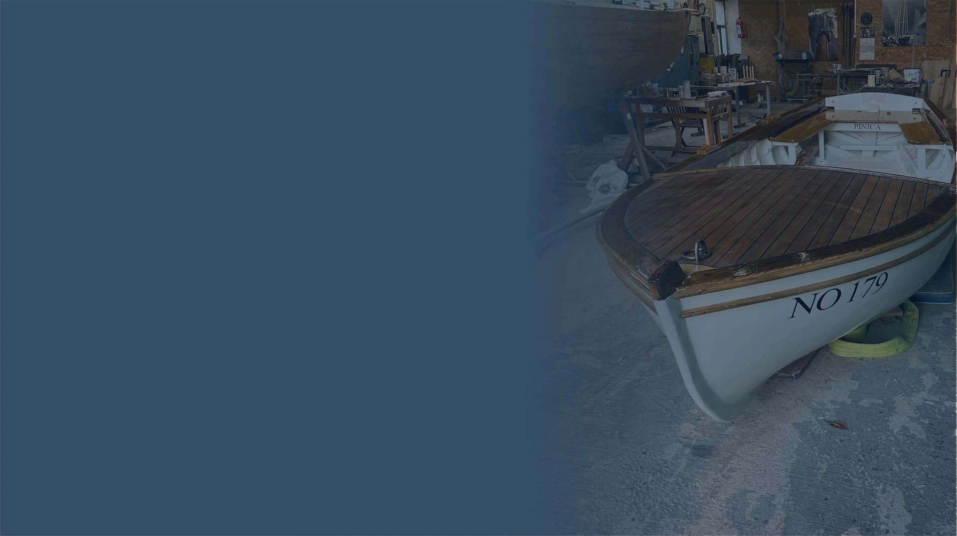 Classic wooden boat in a workshop during restoration and maintenance work